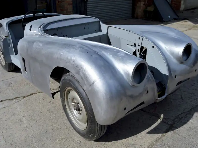 A bare metal 1951 Jaguar XK120 OTS in need of restoration.