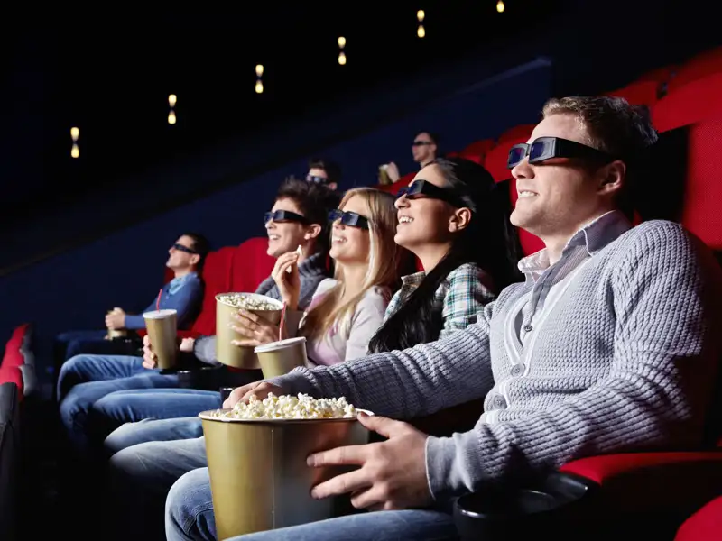 Young people watch movies in cinema.